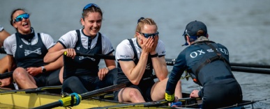 4 members of the Oxford University Women's Boat Race team are seen in their boat after the race end, celebrating their win.
